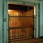 Wooden gate on open side of freight elevator